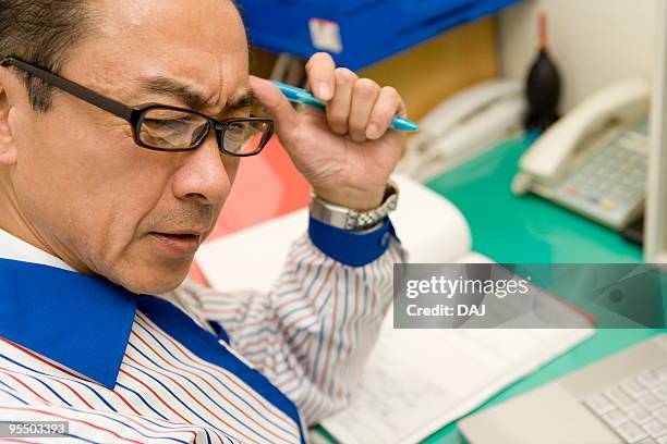 store manager contemplating - itabashi ward stock pictures, royalty-free photos & images