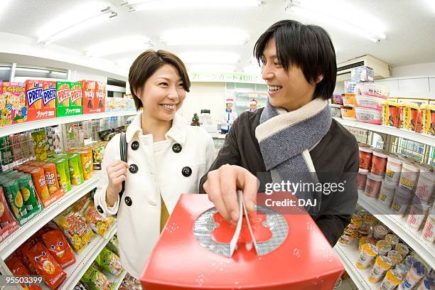 young couple shopping at convenience store - itabashi ward stock pictures, royalty-free photos & images