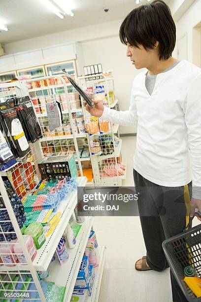 young man shopping at convenience store - itabashi ward stock pictures, royalty-free photos & images