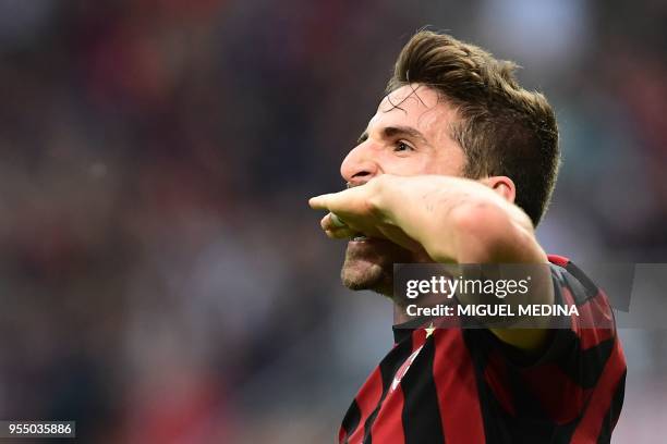 Milan's Italian forward Fabio Borini celebrates after scoring a goal during the Italian Serie A football match between AC Milan and Hellas Verona at...