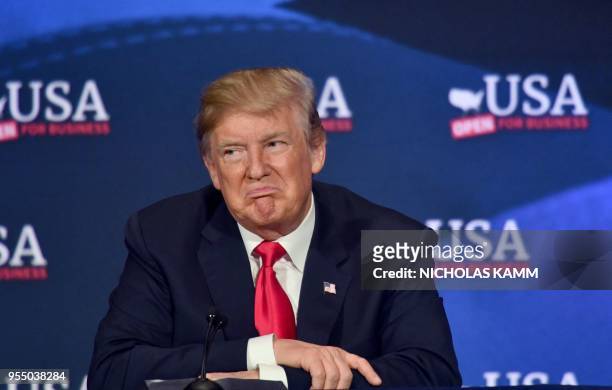 President Donald Trump listens to a question during a roundtable discussion on the new tax law at the Cleveland Public Auditorium and Conference...