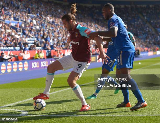 Andy Carroll of West Ham United in action with Wes Morgan of Leicester City during the Premier League match between Leicester City and West Ham...