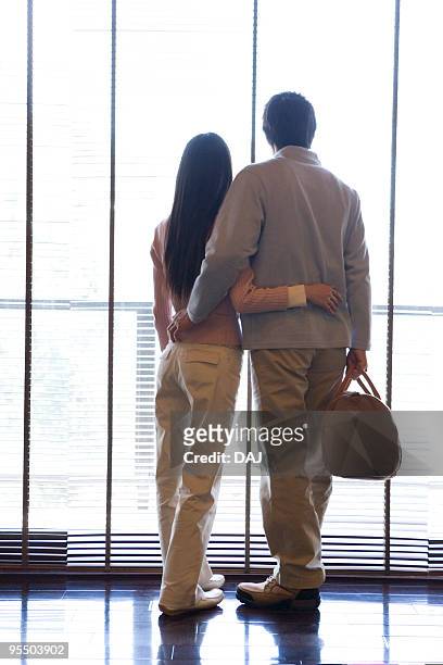 couple standing beside the window - casal de idade mediana - fotografias e filmes do acervo
