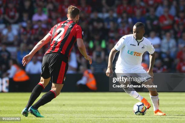 Jordan Ayew of Swansea City is marked by Simon Francis of Bournemouth during the Premier League match between AFC Bournemouth and Swansea City at...