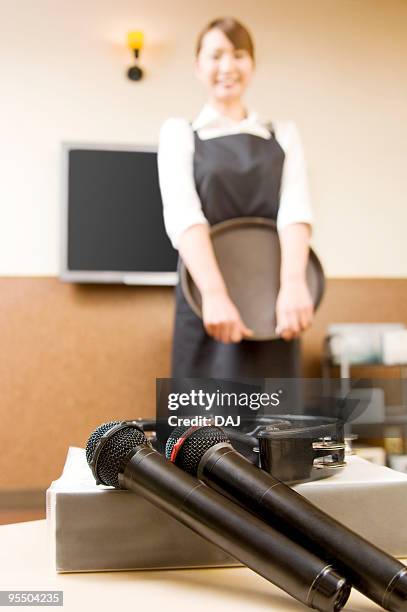 portrait of store clerk at karaoke booth - waitress booth stock pictures, royalty-free photos & images