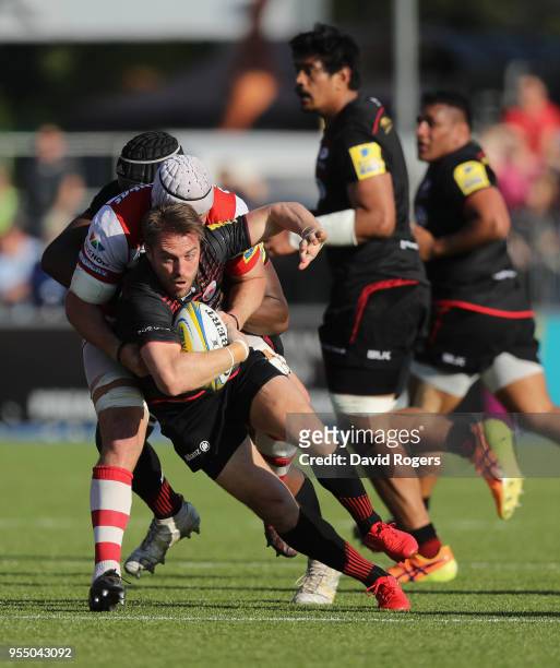 Chris Wyles of Saracens is tackled by Ben Morgan during the Aviva Premiership match between Saracens and Gloucester Rugby at Allianz Park on May 5,...