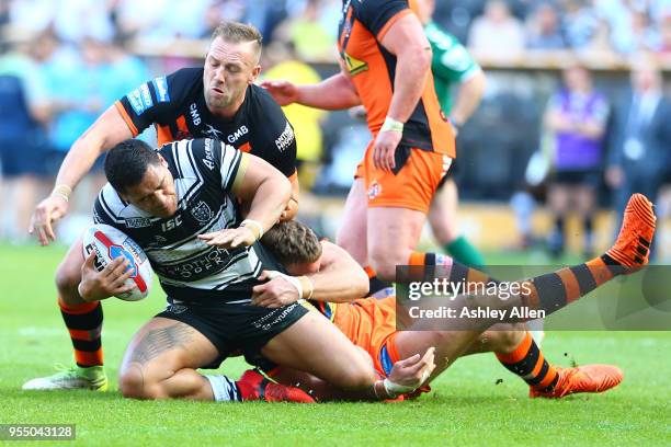 Bureta Faraimo of Hull FC is brought down by two Castleford Tigers players during the Betfred Super League match between Hull FC and Castleford...