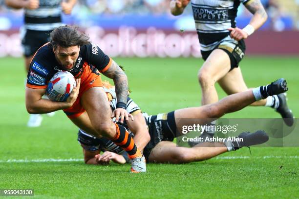 Alex Foster of Castleford Tigers avoids a tackle from Bureta Faraimo of Hull FC during the Betfred Super League match between Hull FC and Castleford...