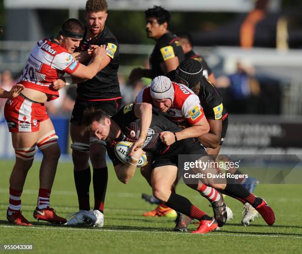 Chris Wyles of Saracens is tackled by Ben Morgan during the Aviva Premiership match between Saracens and Gloucester Rugby at Allianz Park on May 5,...