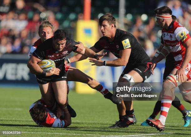 Brad Barritt of Saracens is tackled by Callum Braley during the Aviva Premiership match between Saracens and Gloucester Rugby at Allianz Park on May...