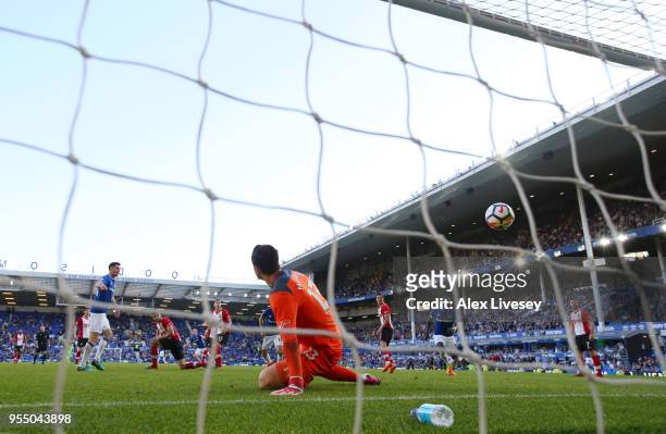 Alex McCarthy of Southampton looks on as Tom Davies of Everton scores his sides first goal during the Premier League match between Everton and...