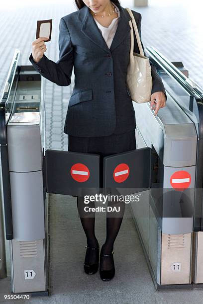 young businesswoman blocked by turnstile at station - 改札 ストックフォトと画像