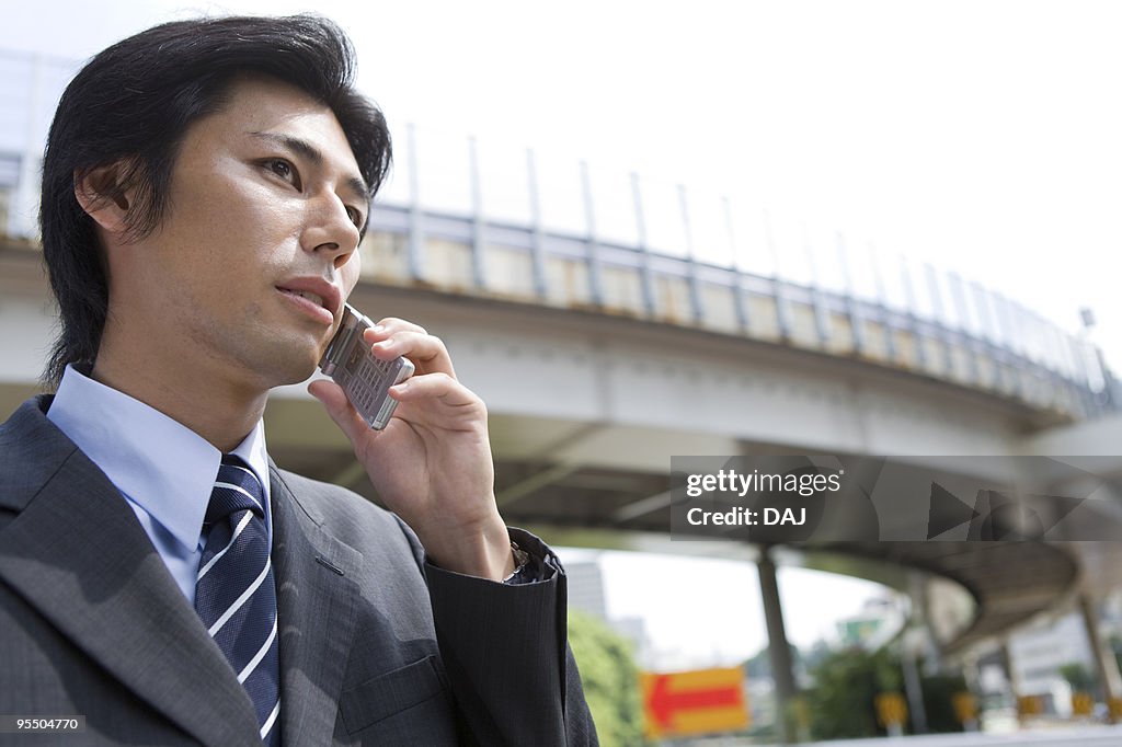 Mid adult man on cell phone outdoors