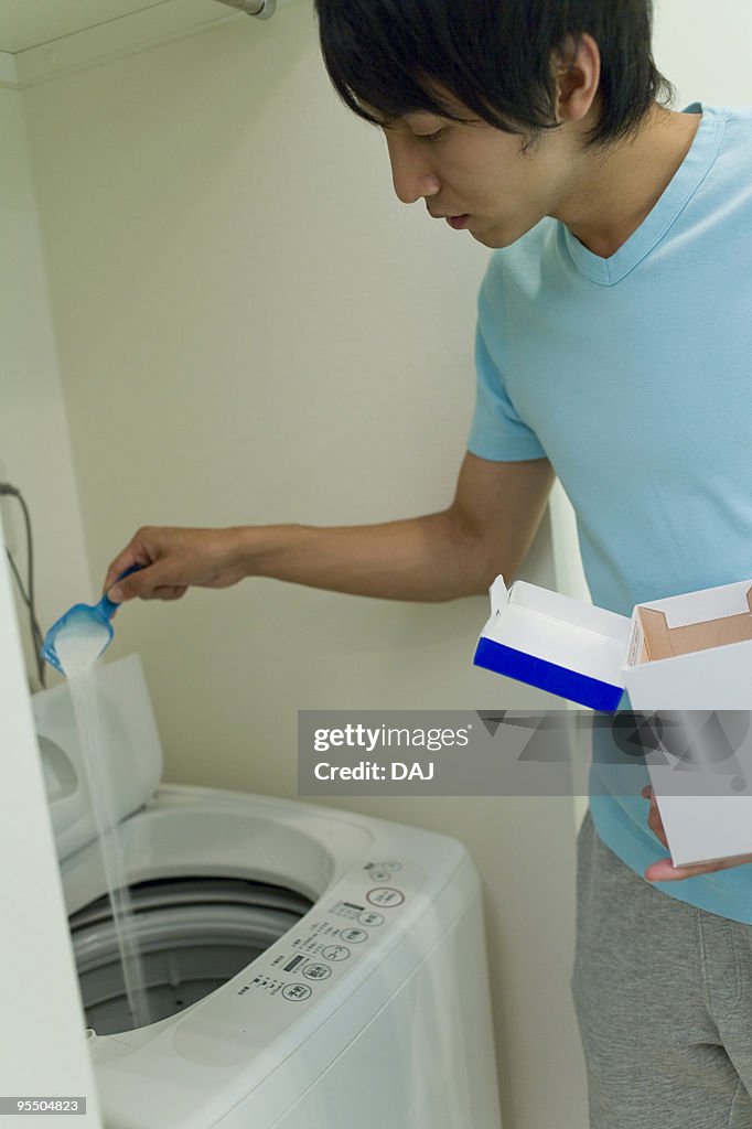 Young man doing laundry