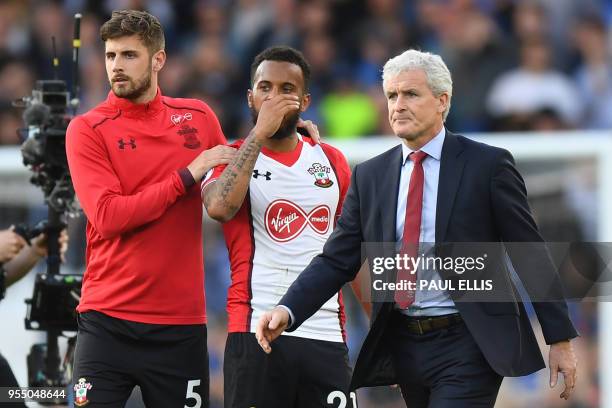 Southampton's English defender Jack Stephens , Southampton's English defender Ryan Bertrand and Southampton Welsh manager Mark Hughes react at the...
