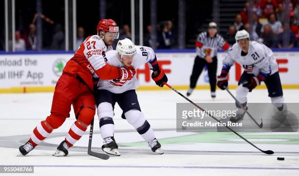 Oliver Bjorkstrand of Denmark and Cam Atkinson of United States battle for the puck during the 2018 IIHF Ice Hockey World Championship group stage...