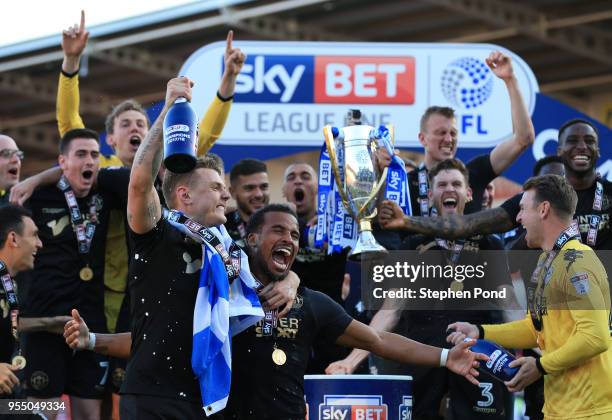 Wigan Athletic lift the trophy as they celebrate becoming League 1 Champions during the Sky Bet League One match between Doncaster Rovers and Wigan...