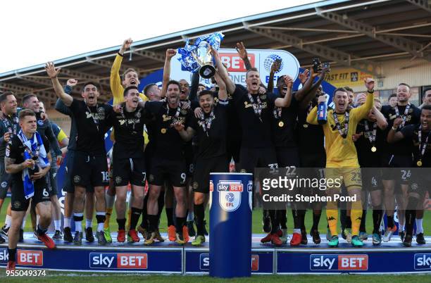 Wigan Athletic lift the trophy as they celebrate becoming League 1 Champions during the Sky Bet League One match between Doncaster Rovers and Wigan...