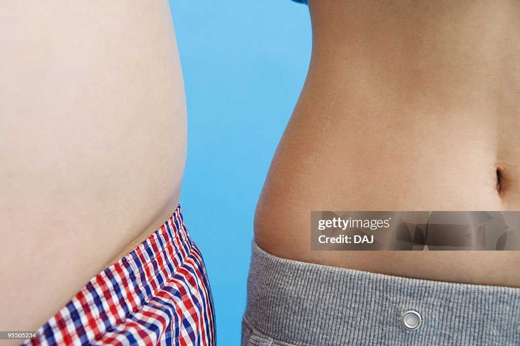 Overweight stomach next to a slim stomach