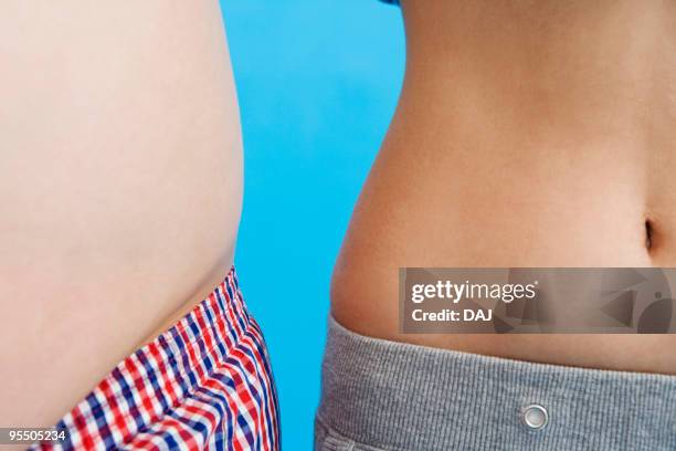 overweight stomach next to a slim stomach - thin to fat stock pictures, royalty-free photos & images