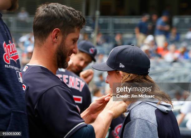 Yan Gomes of the Cleveland Indians braids the hair of theammate Mike Clevinger prior to the start of a game against the New York Yankees at Yankee...