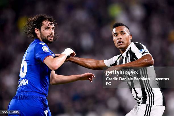 Alex Sandro of Juventus competes for the ball with Andrea Poli of Bologna FC during the serie A match between Juventus and Bologna FC at Allianz...