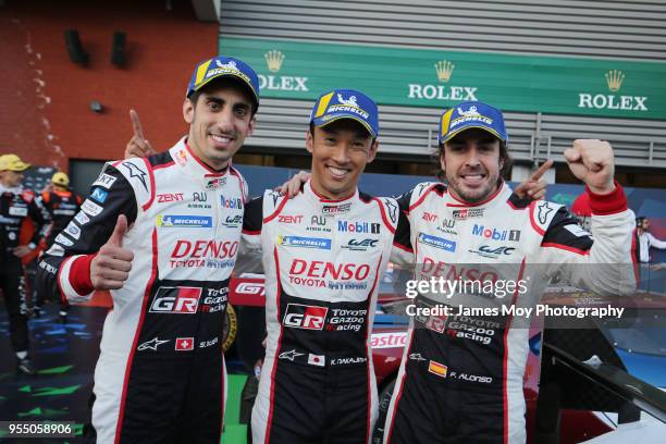 The Toyota Gazoo Racing drivers Sebastien Buemi, Kazuki Nakajima, and Fernando Alonso, celebrate victory in parc ferme at the WEC 6 Hours Of...