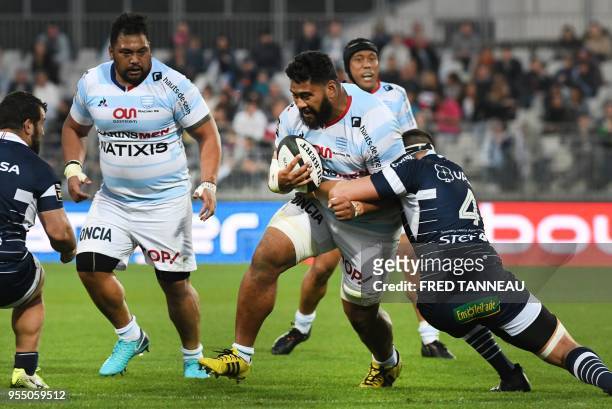 Racing 92's Samoan prop Census Johnston is tackled by Agen's Vakhtangui Akhobadze during the French Top 14 rugby union match between Racing 92 and SU...