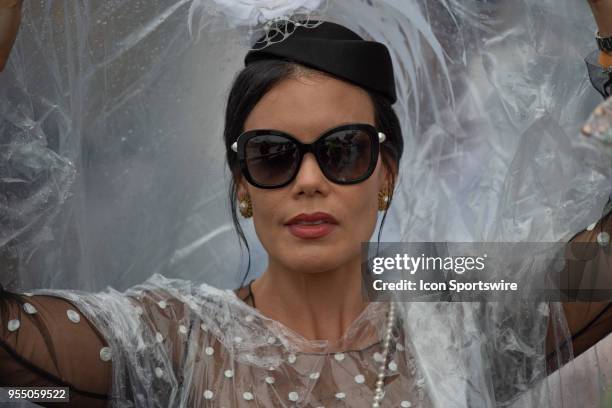 Spectator shields her hat from the rain during the Kentucky Derby on May 5, 2018 at Churchill Downs in Louisville, KY.