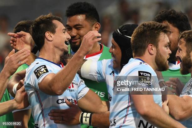 Racing 92's Argentinian winger Juan Imhoff celebrates with teammates after scoring during the French Top 14 rugby union match between Racing 92 and...