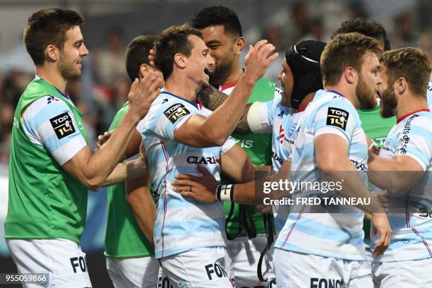 Racing 92's Argentinian winger Juan Imhoff celebrates with teammates after scoring during the French Top 14 rugby union match between Racing 92 and...