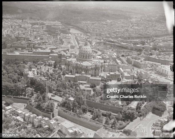 Aerial view of vatican gardens and vatican city from western border, The dome of St. Peter's Basilica rises above the walls and gardens separating...