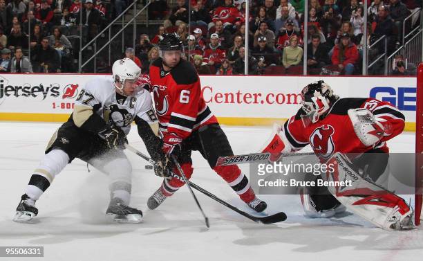 Andy Greene and goaltender Martin Brodeur of the New Jersey Devils combine to stop Sidney Crosby of the Pittsburgh Penguins at the Prudential Center...