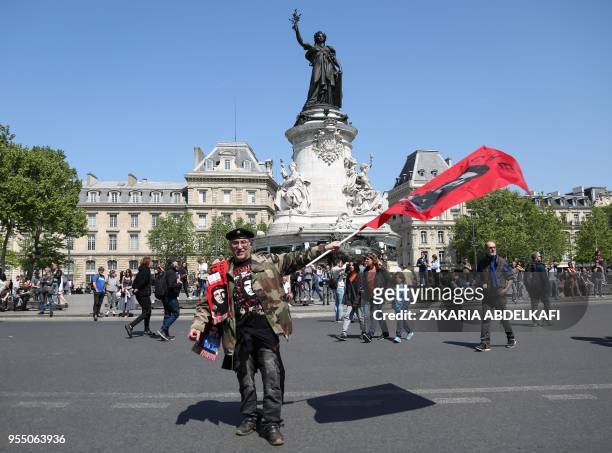 Protester waving a flag of "Che Guevara" takes part in a protest dubbed a "Party for Macron" against the policies of the French president on the...