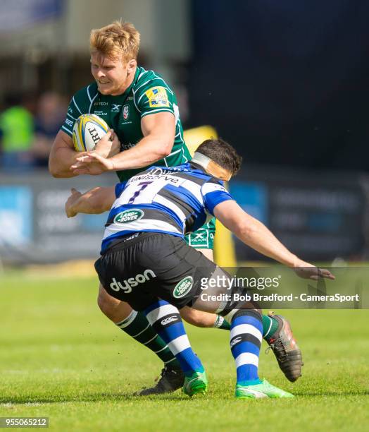 London Irish's Joshua McNally is tackled by Bath Rugby's Francois Louw during the Aviva Premiership match between Bath Rugby and London Irish at...