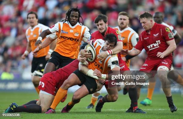 Francois Venter of Cheetahs is held by Hadleigh Parkes of Scarlets and Dan Jones of Scarlets during the Guinness Pro14 match between Scarlets and...