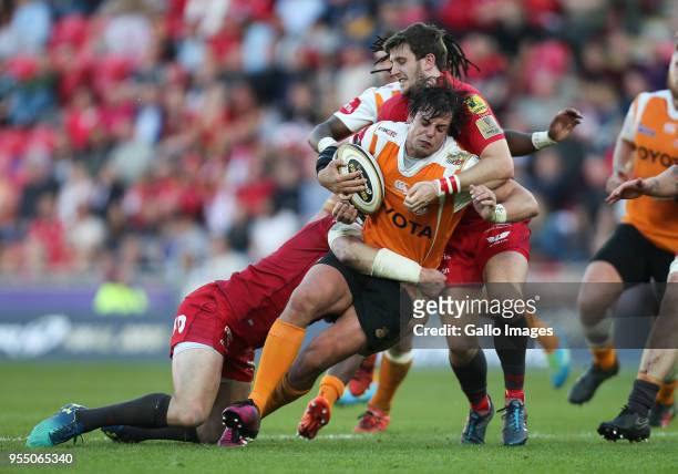 Francois Venter of Cheetahs is held by Hadleigh Parkes of Scarlets and Dan Jones of Scarlets during the Guinness Pro14 match between Scarlets and...