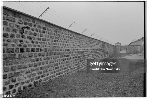 Electric fence and courtyard, A brick electric fence surrounds the execution courtyard at Mauthausen, a Nazi concentration camp in operation during...