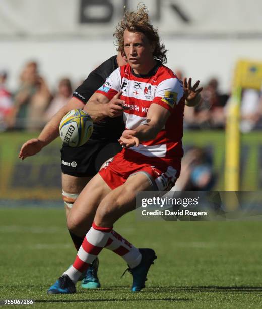 Billy Twelvetrees of Gloucester passes the ball as Jackson Wray tackles during the Aviva Premiership match between Saracens and Gloucester Rugby at...