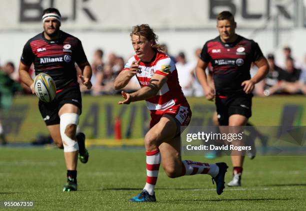 Billy Twelvetrees of Gloucester passes the ball as Jackson Wray tackles during the Aviva Premiership match between Saracens and Gloucester Rugby at...
