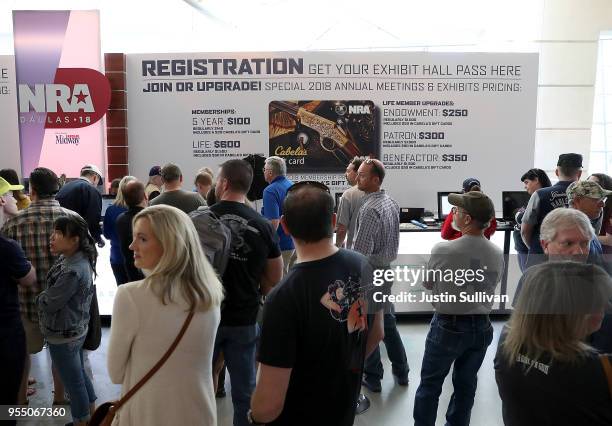 Attendees line up to become registered members of the National Rifle Association during the NRA Annual Meeting & Exhibits at the Kay Bailey Hutchison...