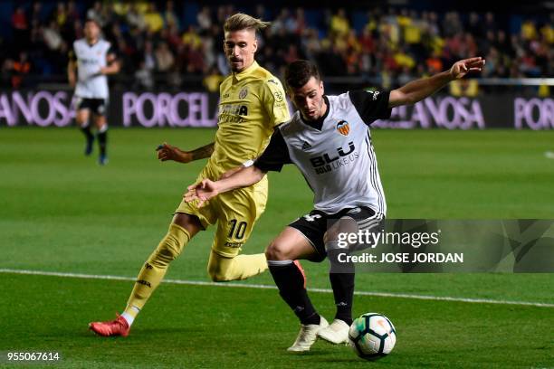 Villarreal's Spanish midfielder Samuel Castillejo challenges Valencia's Spanish defender Jose Gaya during the Spanish league football match between...