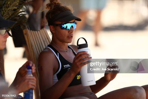 Brandie Wilkerson of Canada rests during a break during the match against Brooke Sweat and Lauren Fendrick of USA at the Huntington Beach Open on May...