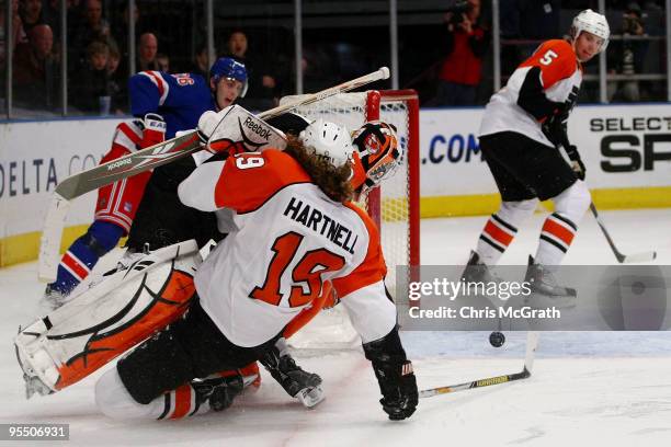 Scott Hartnell of the Philadelphia Flyers and goal keeper Michael Leighton defend a shot at goal against the New York Rangers during their game on...