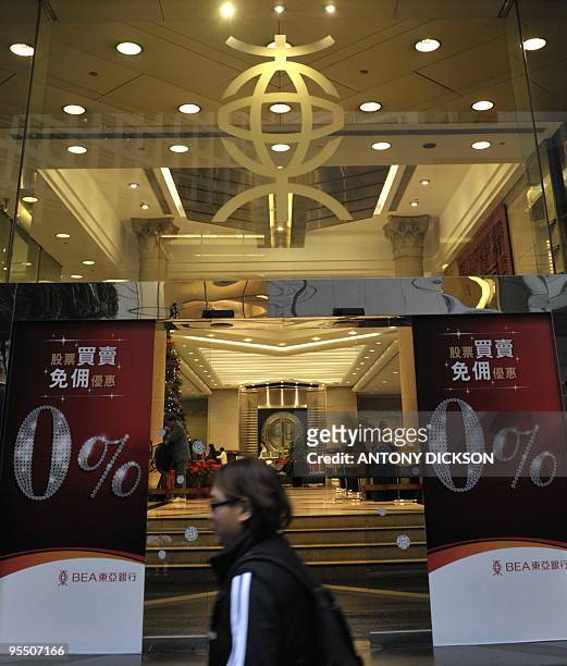 Pedestrian walks past the Bank of East Asia's headquarters in Hong Kong on December 31, 2009. Spain's La Caixa said on December 30 it had reached an...
