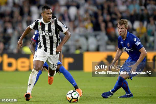 Alex Sandro of Juventus competes for the ball with Emil Krafth of Bologna FC during the serie A match between Juventus and Bologna FC at Allianz...