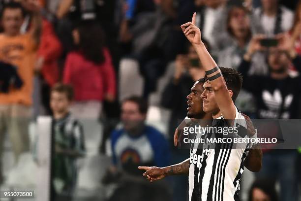 Juventus' forward Paulo Dybala from Argentina celebrates with teammate Juventus' midfielder Douglas Costa from Brazil after scoring a goal during the...