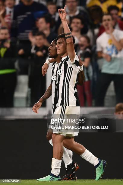 Juventus' forward Paulo Dybala from Argentina celebrates with teammate Juventus' midfielder Douglas Costa from Brazil after scoring a goal during the...