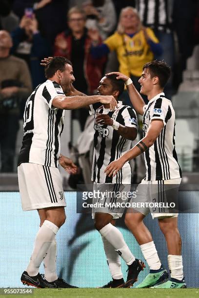 Juventus' forward Paulo Dybala from Argentina celebrates with teammate Juventus' midfielder Douglas Costa from Brazil and Juventus' defender Andrea...