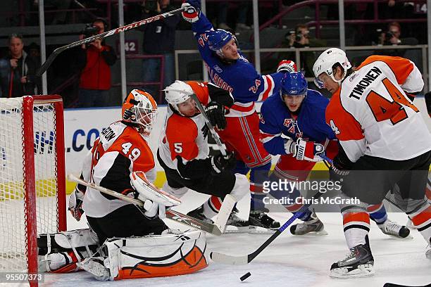 Goalkeeper Michael Leighton of the Philadelphia Flyers and team mate Kimmo Timonen defend a shot at goal by the New York Rangers during their game on...